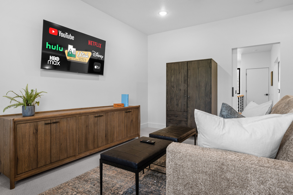 Upstairs family suite featuring entertainment space and sleeping accommodations.