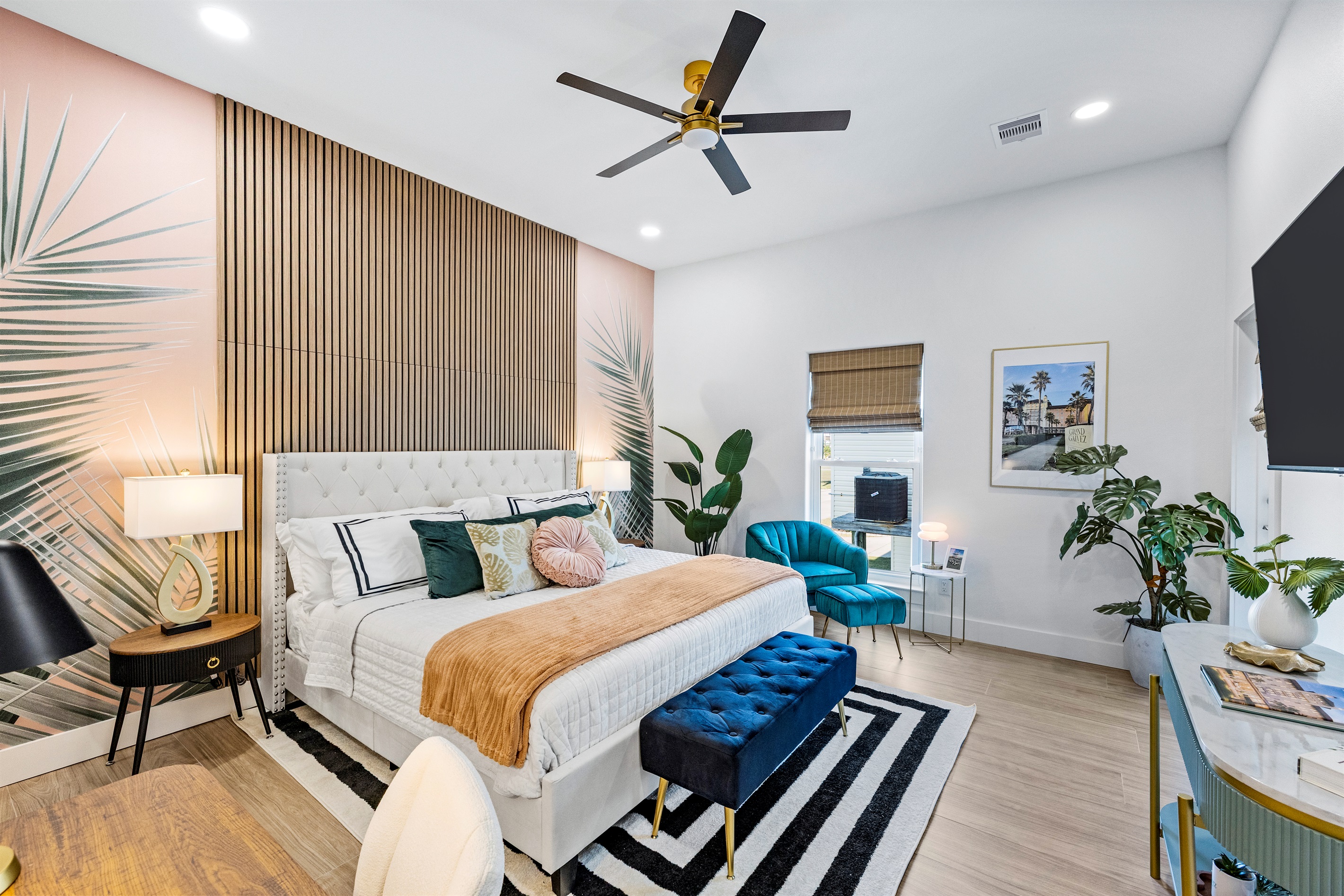 Palms of Grand Galvez primary suite. This first floor king bedroom includes a desk, direct porch access, ensuite bathroom and a 50" tv.