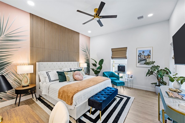 Palms of Grand Galvez primary suite. This first floor king bedroom includes a desk, direct porch access, ensuite bathroom and a 50" tv.