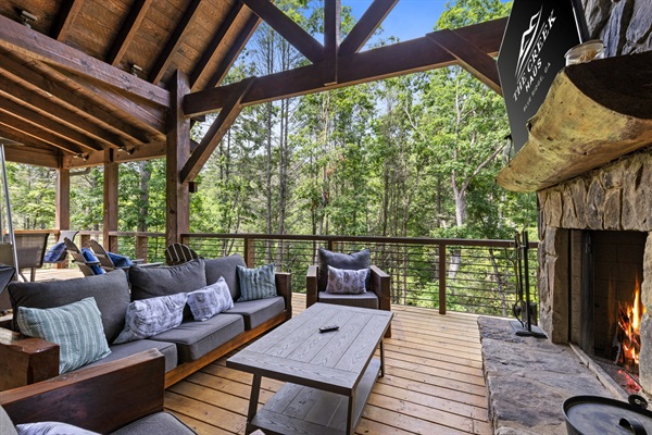 Cozy up by the fire and take in the serene mountain views from this stunning outdoor living space — the perfect place to unwind, sip your favorite drink, and connect with nature.
