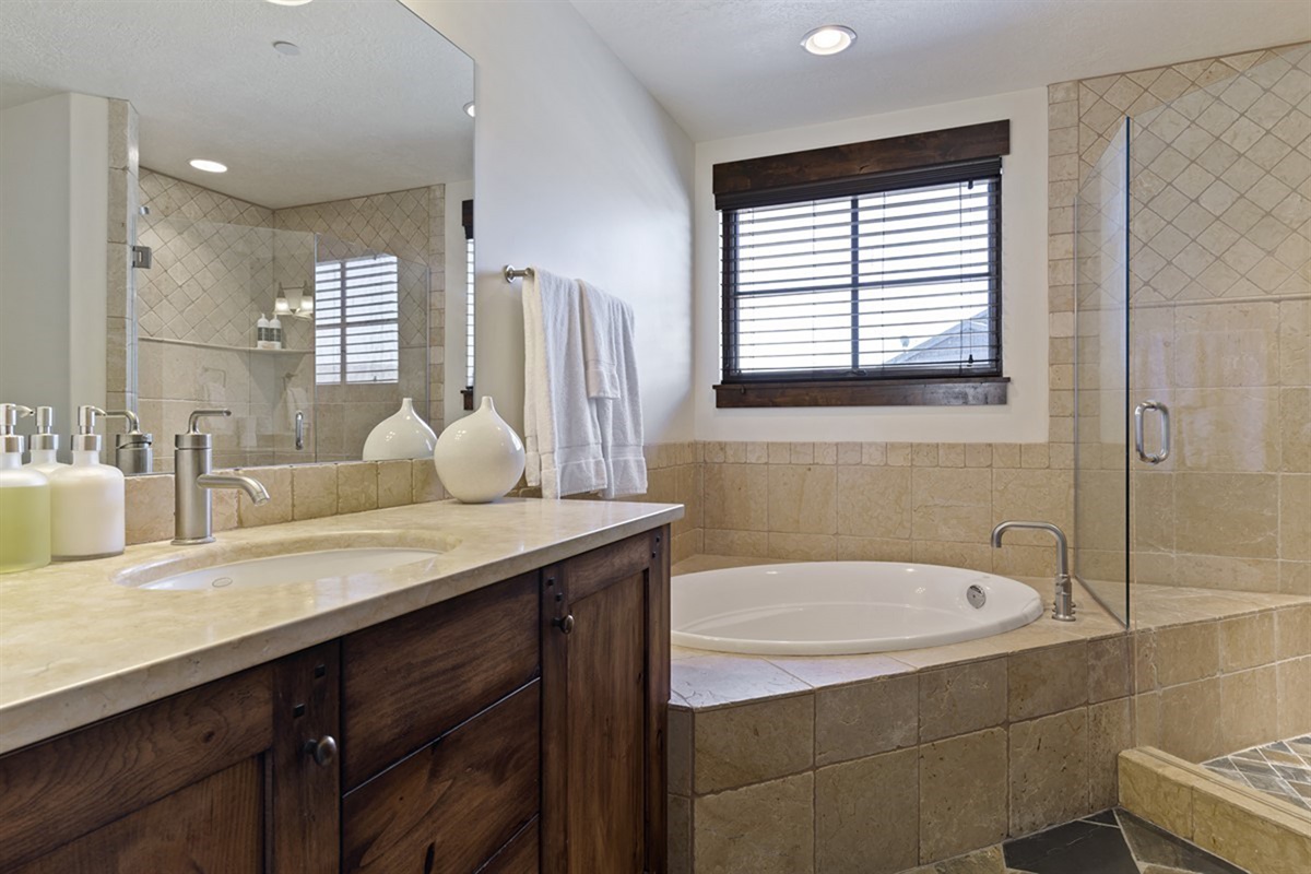 A well-appointed bathroom complete with tub, shower, and expansive vanity—offering both functionality and a spa-like feel.