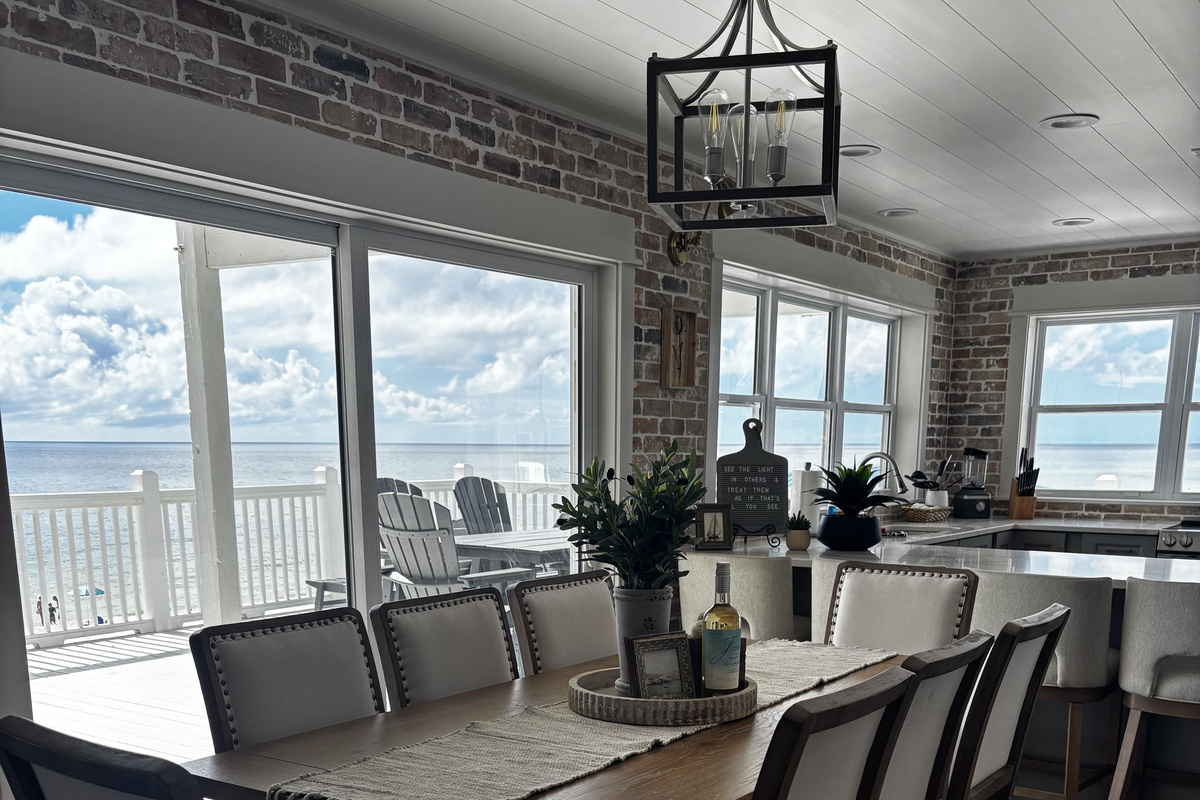 8 person dining table inside, 8 person outdoor dining area, and 4 bar stools.