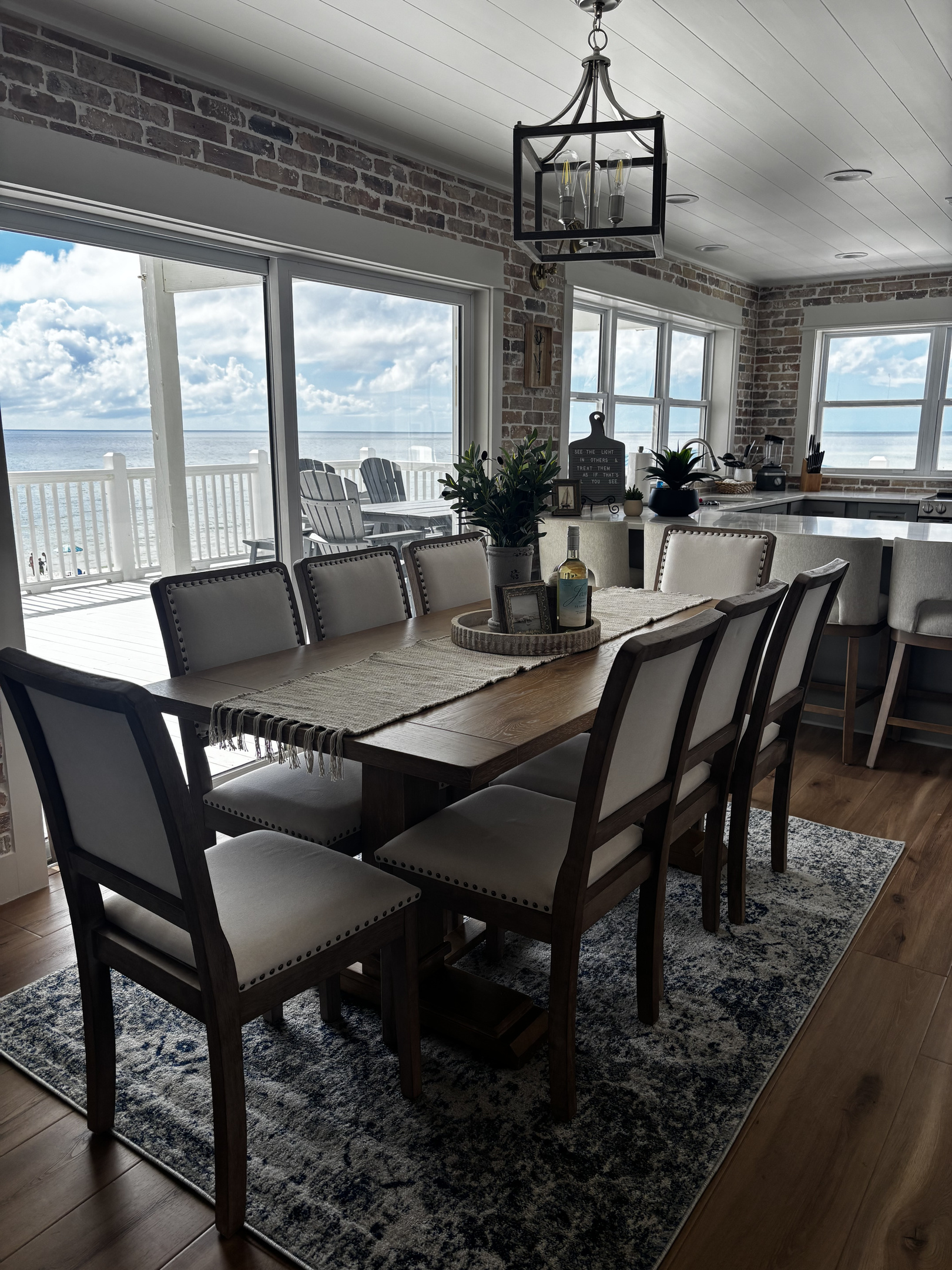 8 person dining table inside, 8 person outdoor dining area, and 4 bar stools.