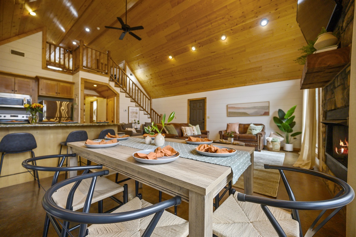 Our cabin's spacious dining area seamlessly blends into the modern kitchen and cozy living room, creating the perfect ambiance for dining, cooking, and unwinding.