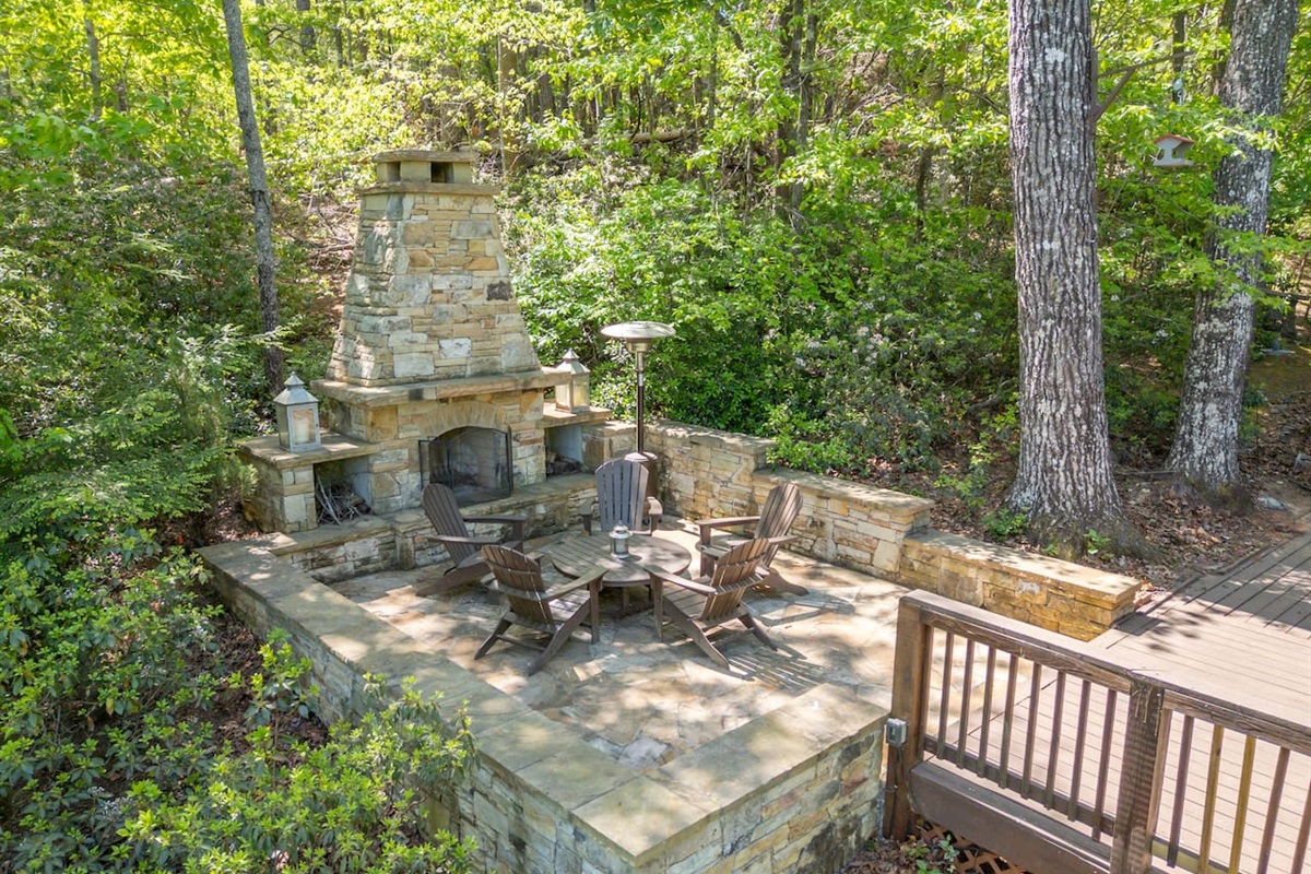 Stone fireplace connected to main-level deck