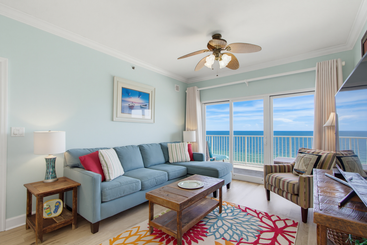 Comfortable Gulf-front living room with a wall-mounted TV.