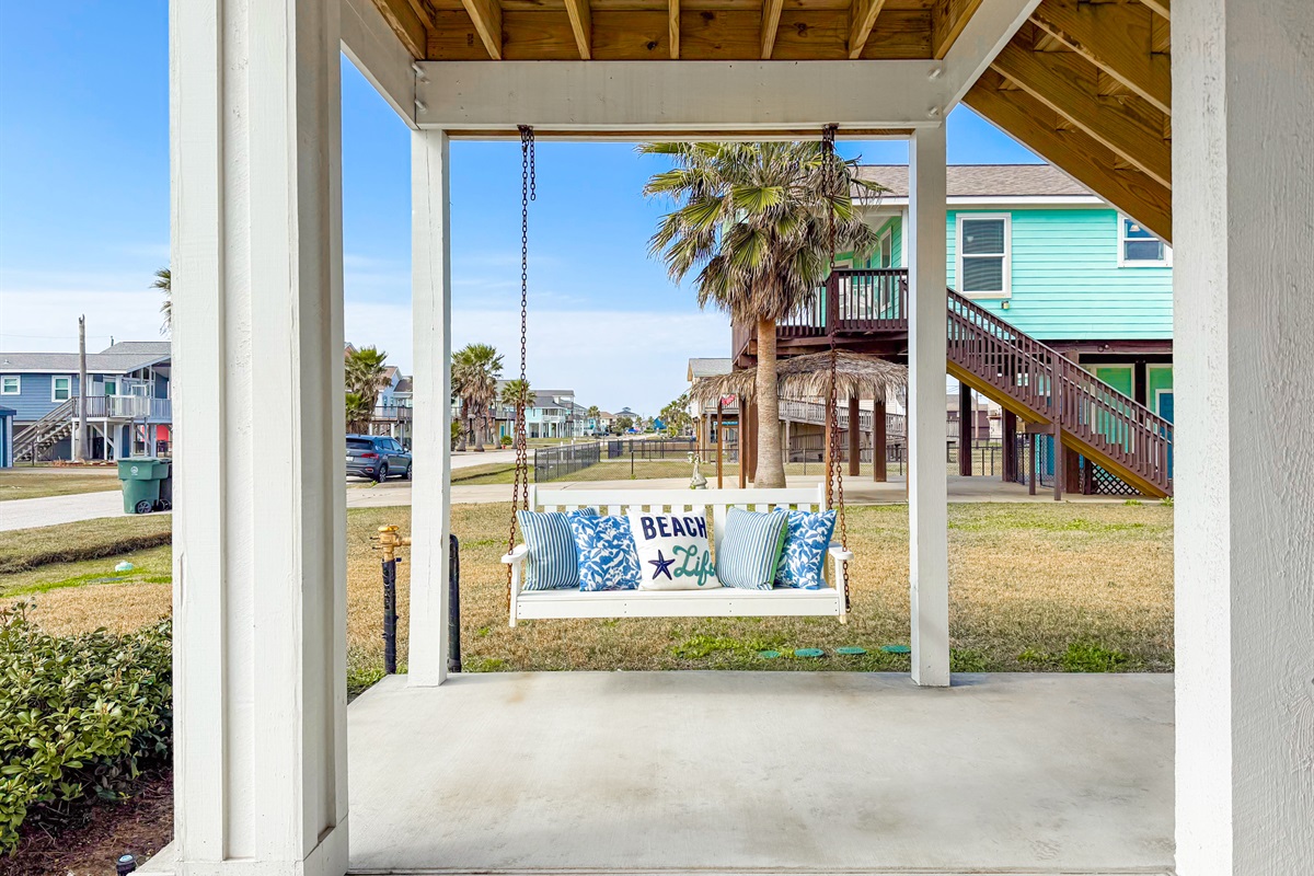 Have a quick read or a nap on the swinging bench seat in the carport.