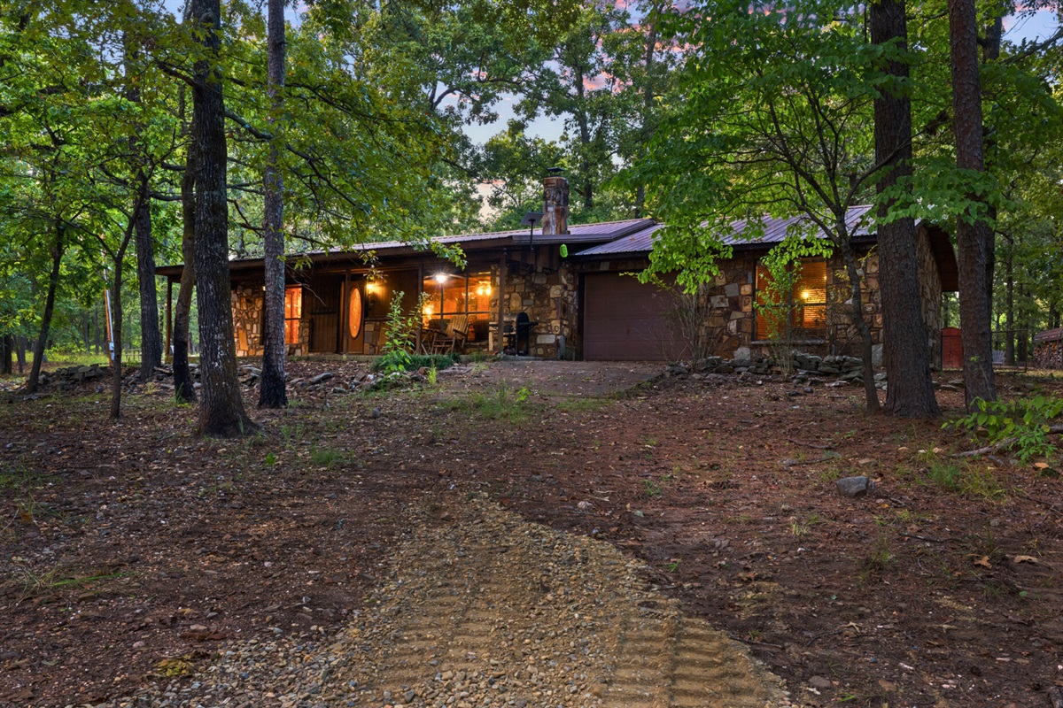 Front view of the cabin nestled in the trees.
