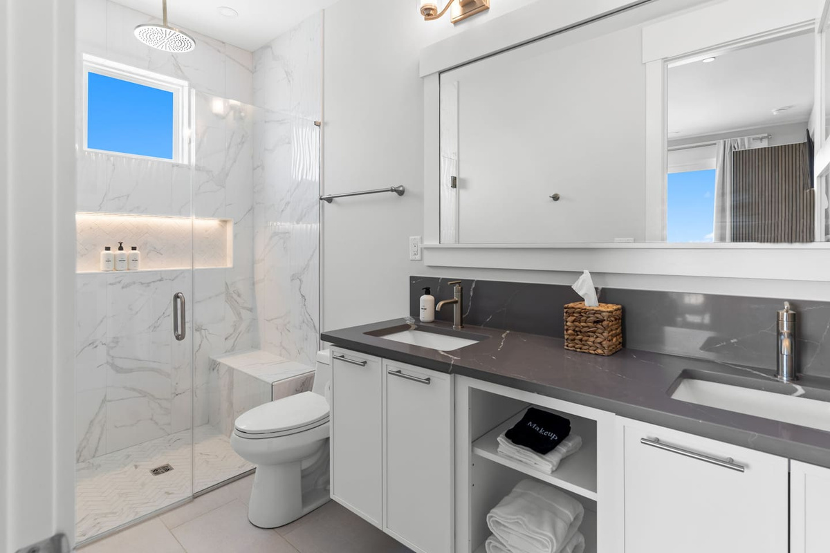 Thoughtfully designed for every guest, each bathroom features spacious curbless showers with built-in benches, blending accessibility with modern comfort and style.