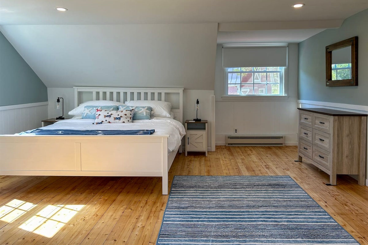 The primary bedroom suite is accessed by a private staircase leading to a bedroom, bathroom, and workspace. 