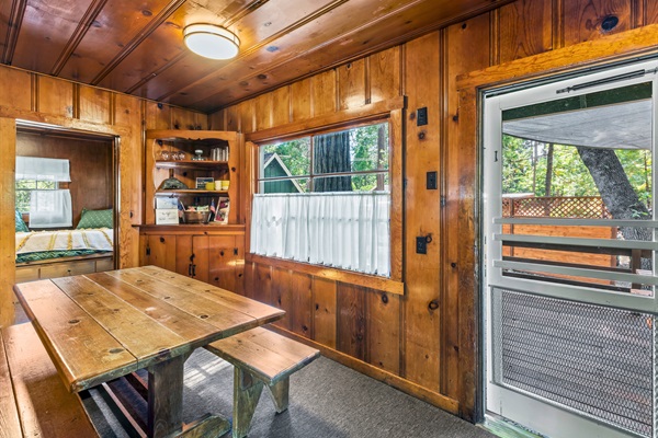 A warm dining nook opens to the deck, offering a perfect spot for casual meals and time together.