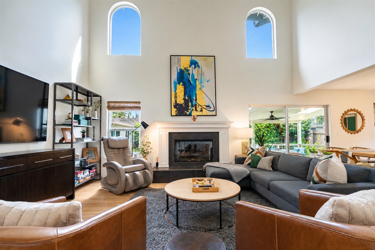 Living area with smart tv, massage chair and fireplace.