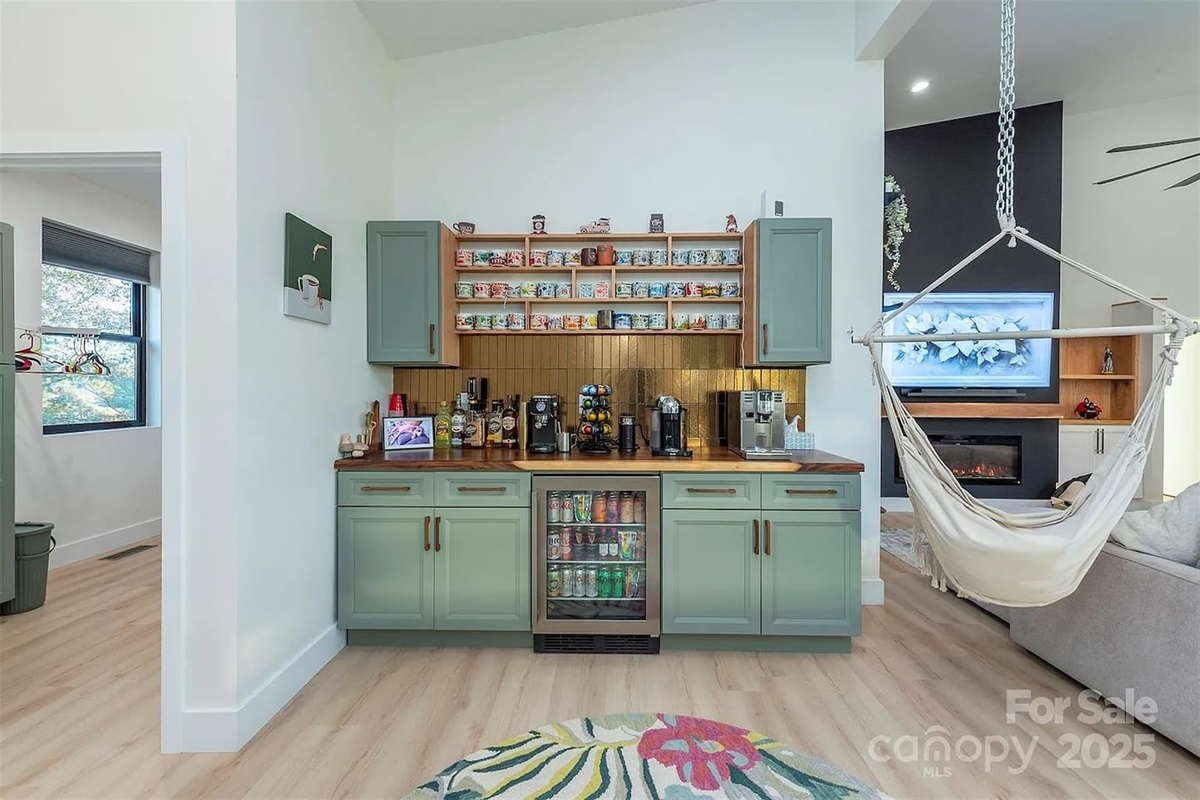 Charming café-style beverage station with custom cabinetry, multiple coffee machines, snack storage, and a mini drink fridge.