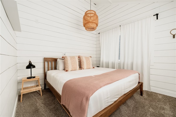 Primary beach view bedroom w/ king size bed. 