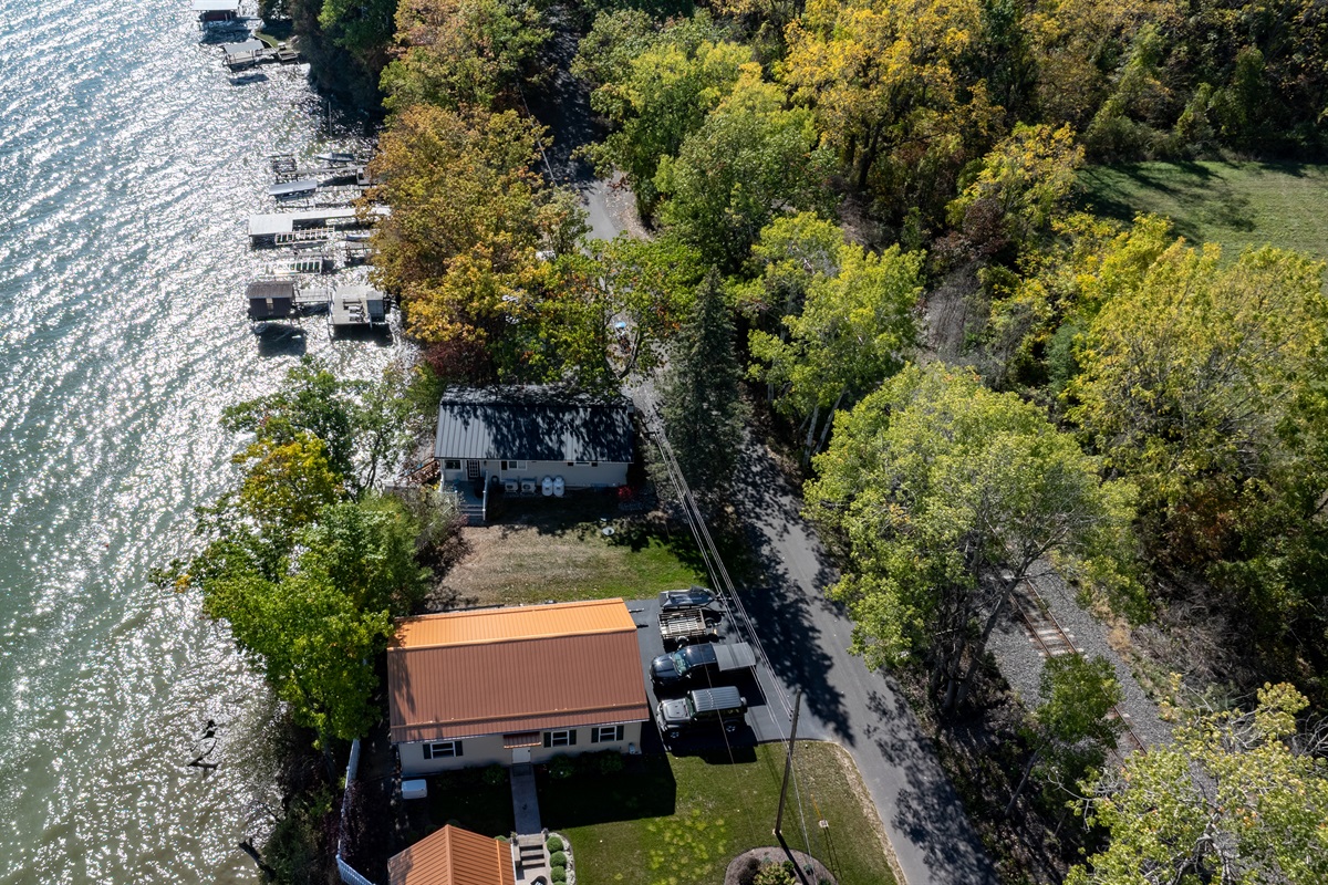 Picturesque waterfront hideaway with private dock and stunning fall colors all around.