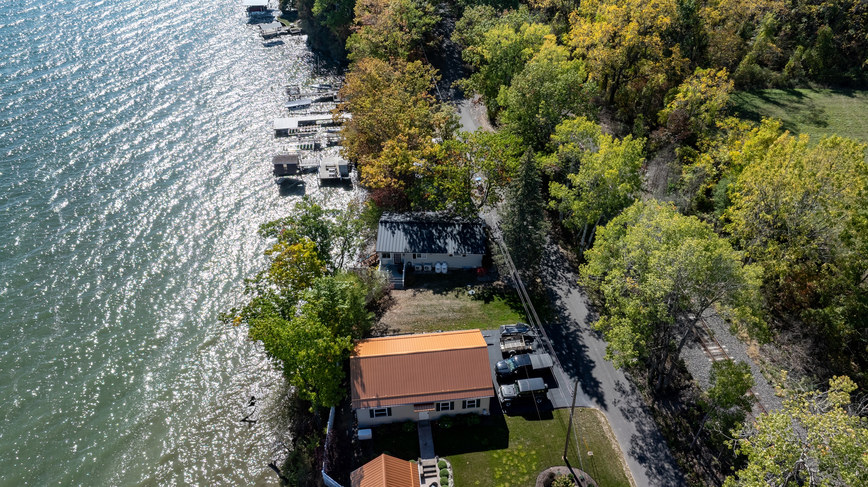 Picturesque waterfront hideaway with private dock and stunning fall colors all around.