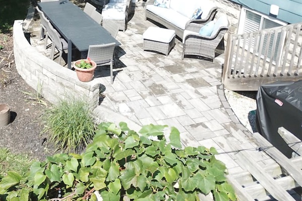 Dining and sitting area and gas grill in private, fenced yard.