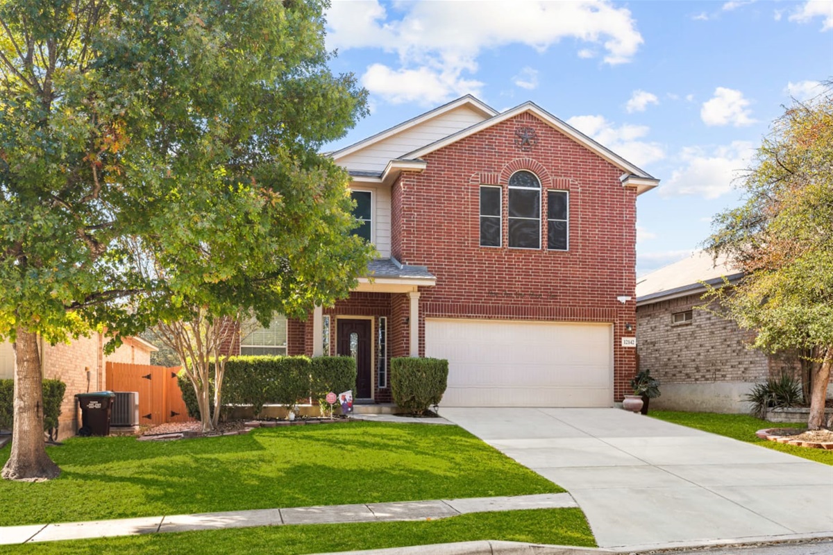 Freshly captured front exterior with charming curb appeal, private driveway, and keyless entry in a quiet San Antonio neighborhood near SeaWorld.