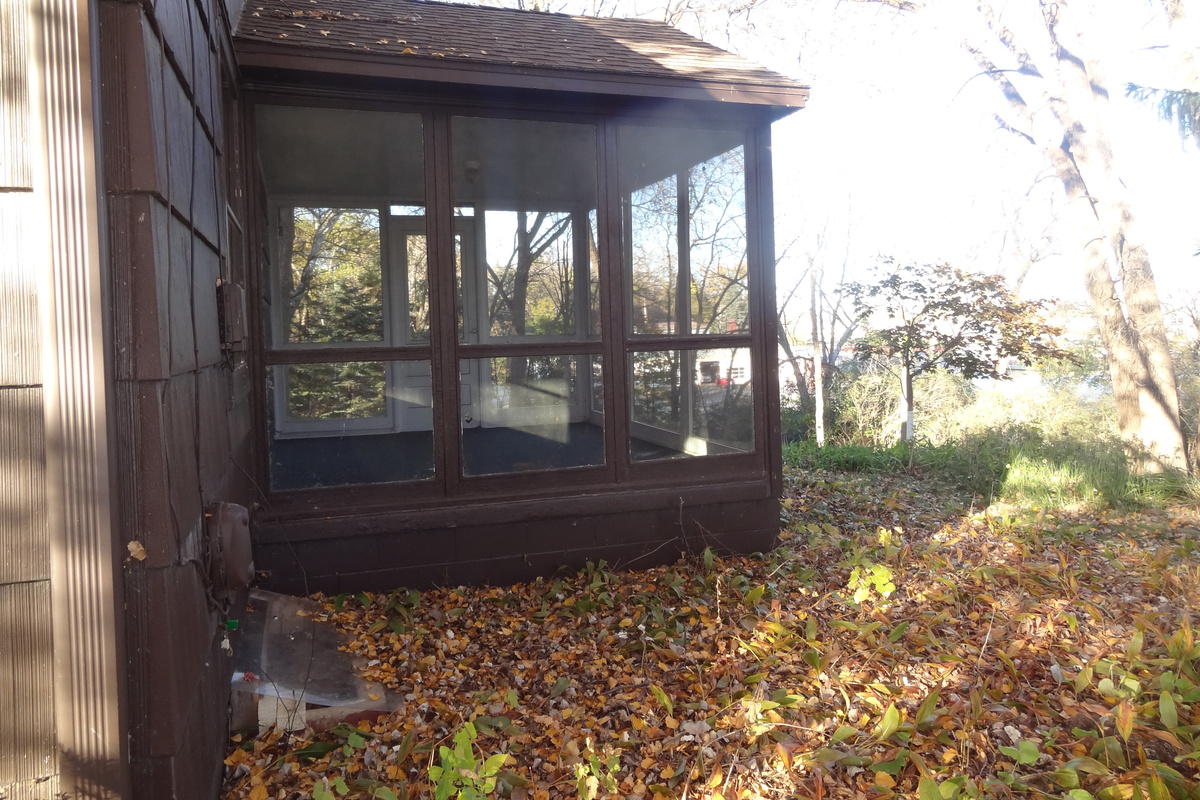 Three season porch off of living room with access to backyard