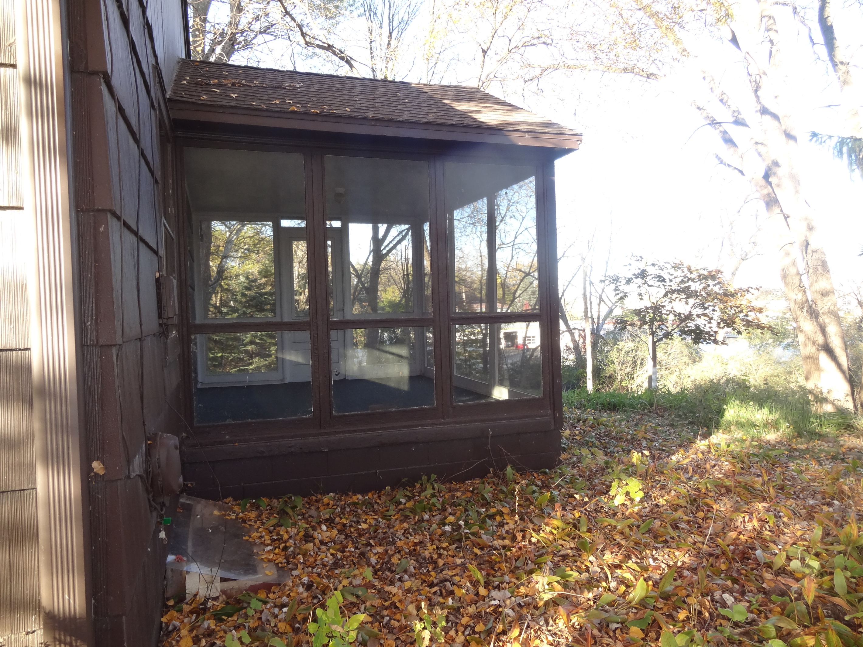 Three season porch off of living room with access to backyard