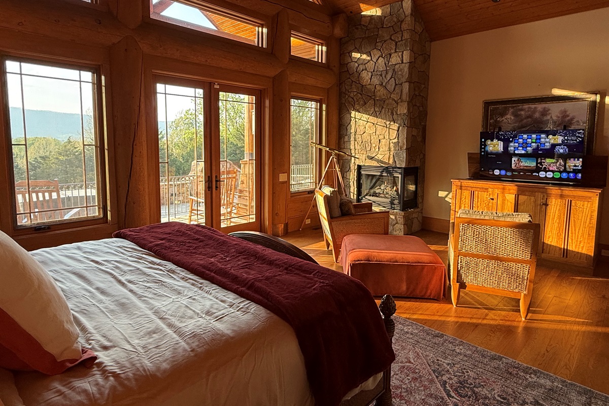 Spacious master bedroom featuring a comfortable king bed and a cozy propane fireplace