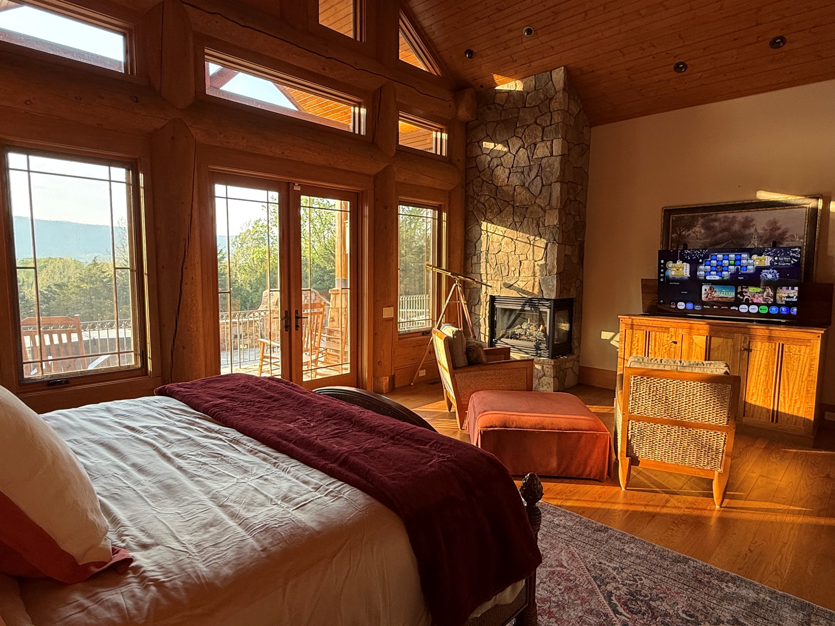 Spacious master bedroom featuring a comfortable king bed and a cozy propane fireplace