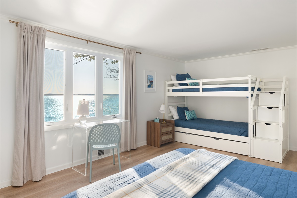 The kids will enjoy hanging in their space in a bunk bed with a trundle to sleep 3 in addition to the queen bed. 