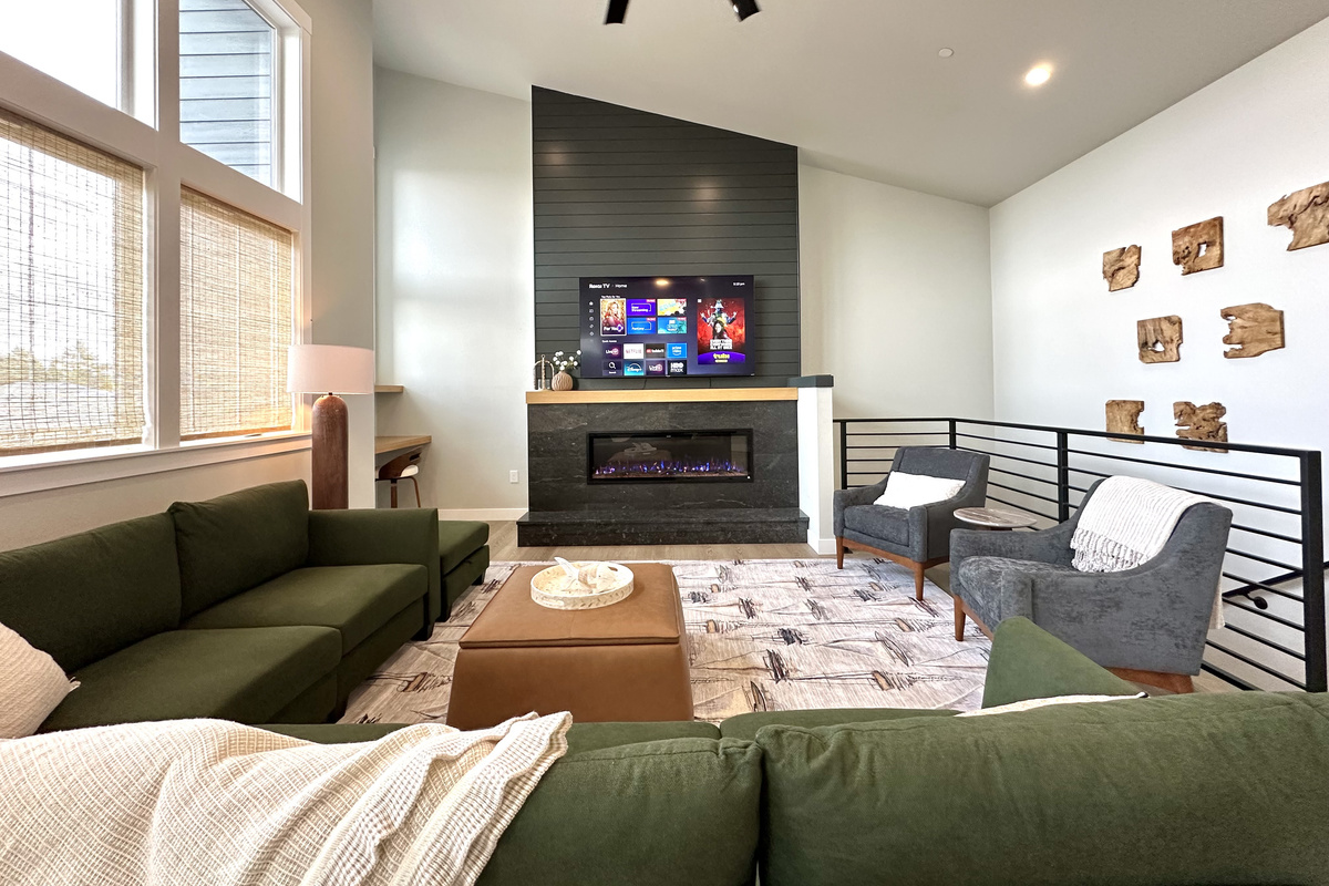 Fireplace on, big screen rolling — the great room is built for winding down together.