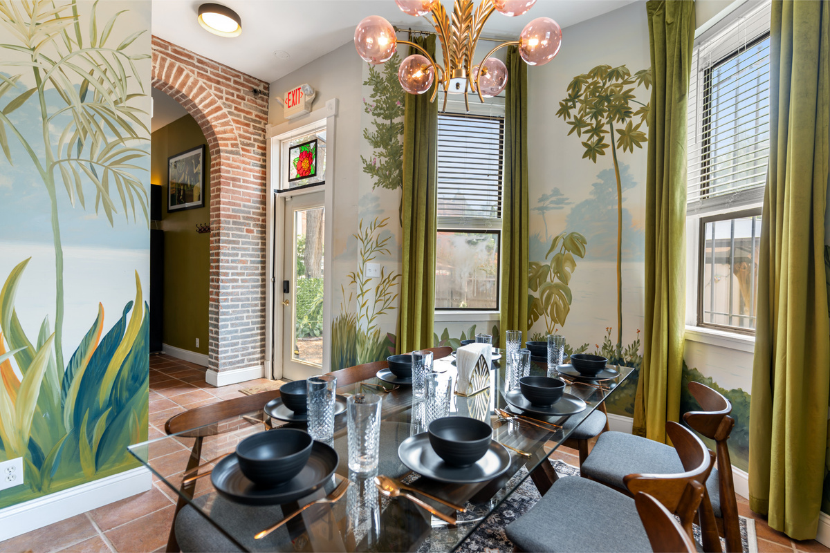 Gather around the table beneath walls hand-painted by the artist who calls Ch&acirc;teau d&rsquo;Art home.