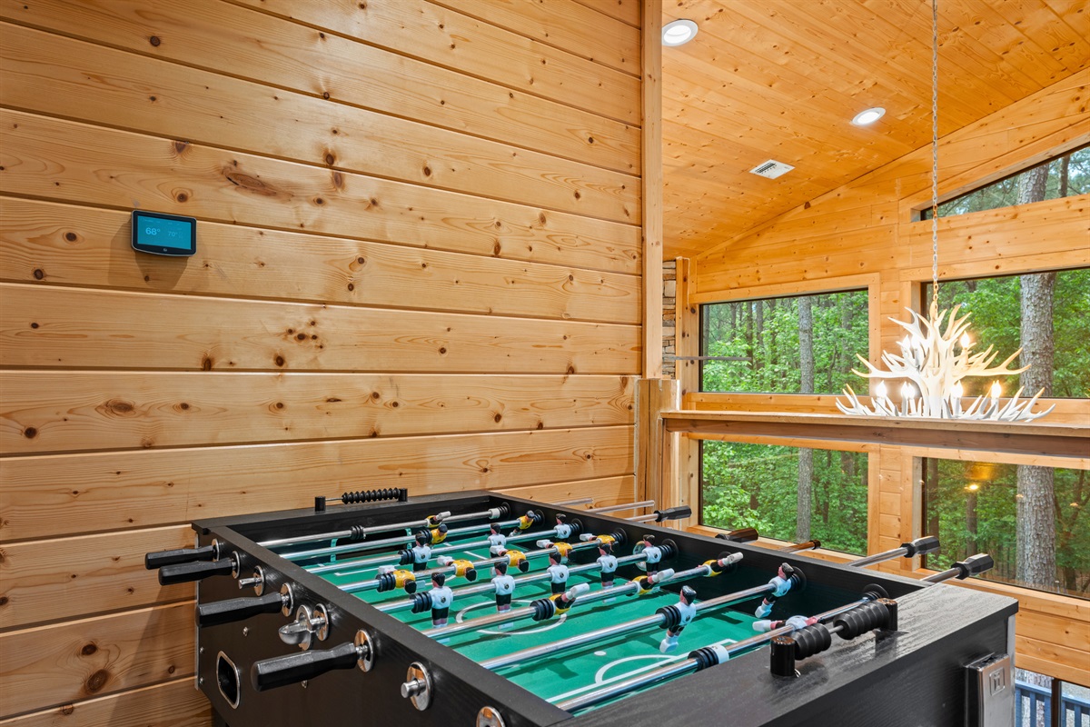 Foosball brings a lively energy to the room, offering another fun way to pass the time indoors.