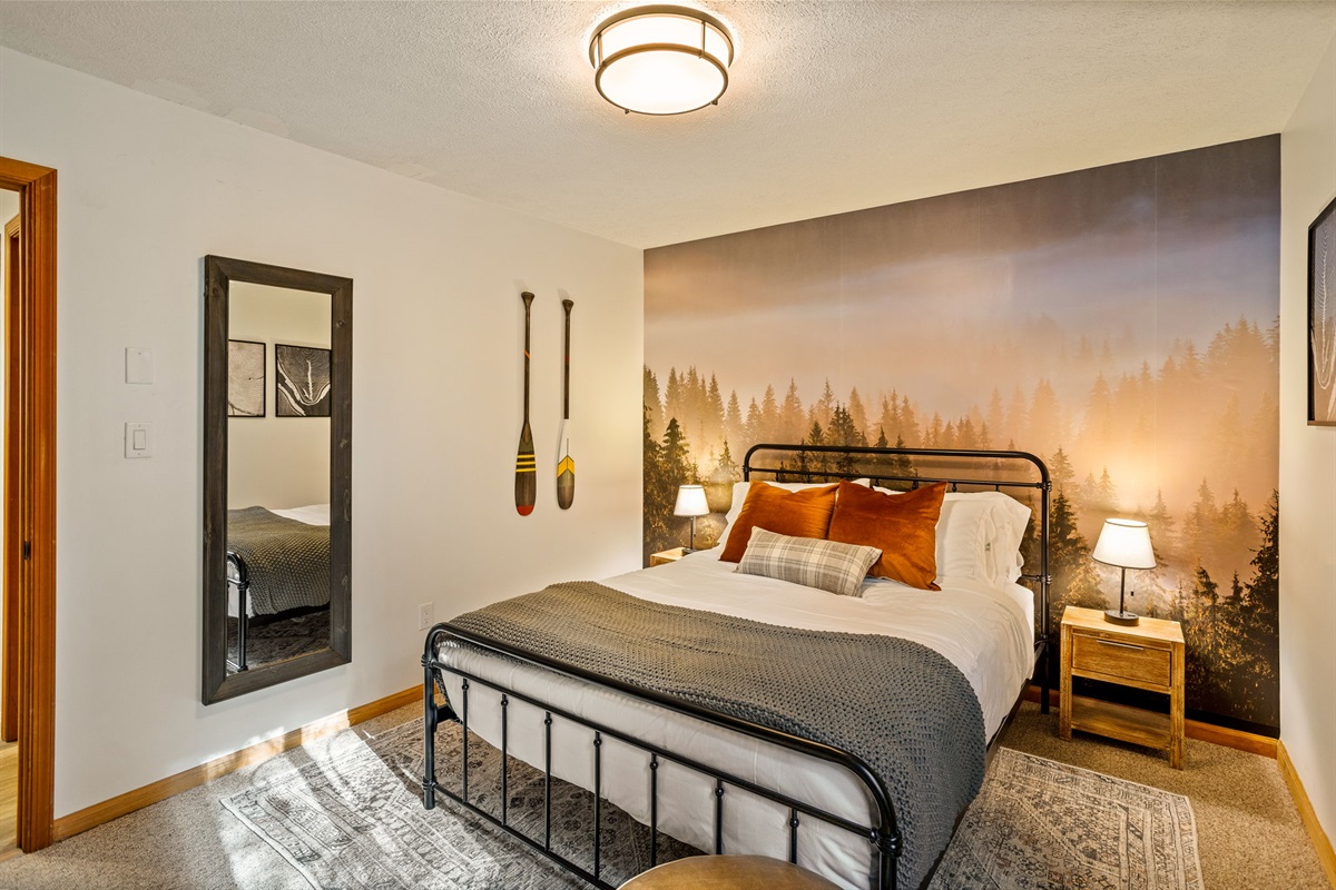 Wake up surrounded by the Poconos! This forest mural bedroom blends rustic charm with comfort for a truly restful night