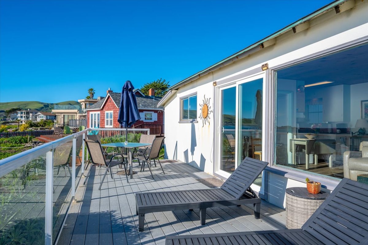 Lounge chairs and dining table on deck