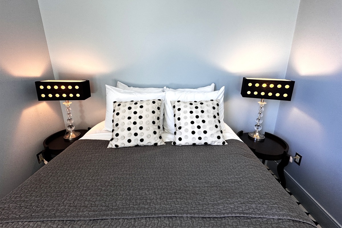 Sophisticated symmetry in the "Sky Loft" queen suite. From the designer lamps to the custom textiles, every detail has been chosen to create a modern, boutique-style retreat at the summit of The Crag.