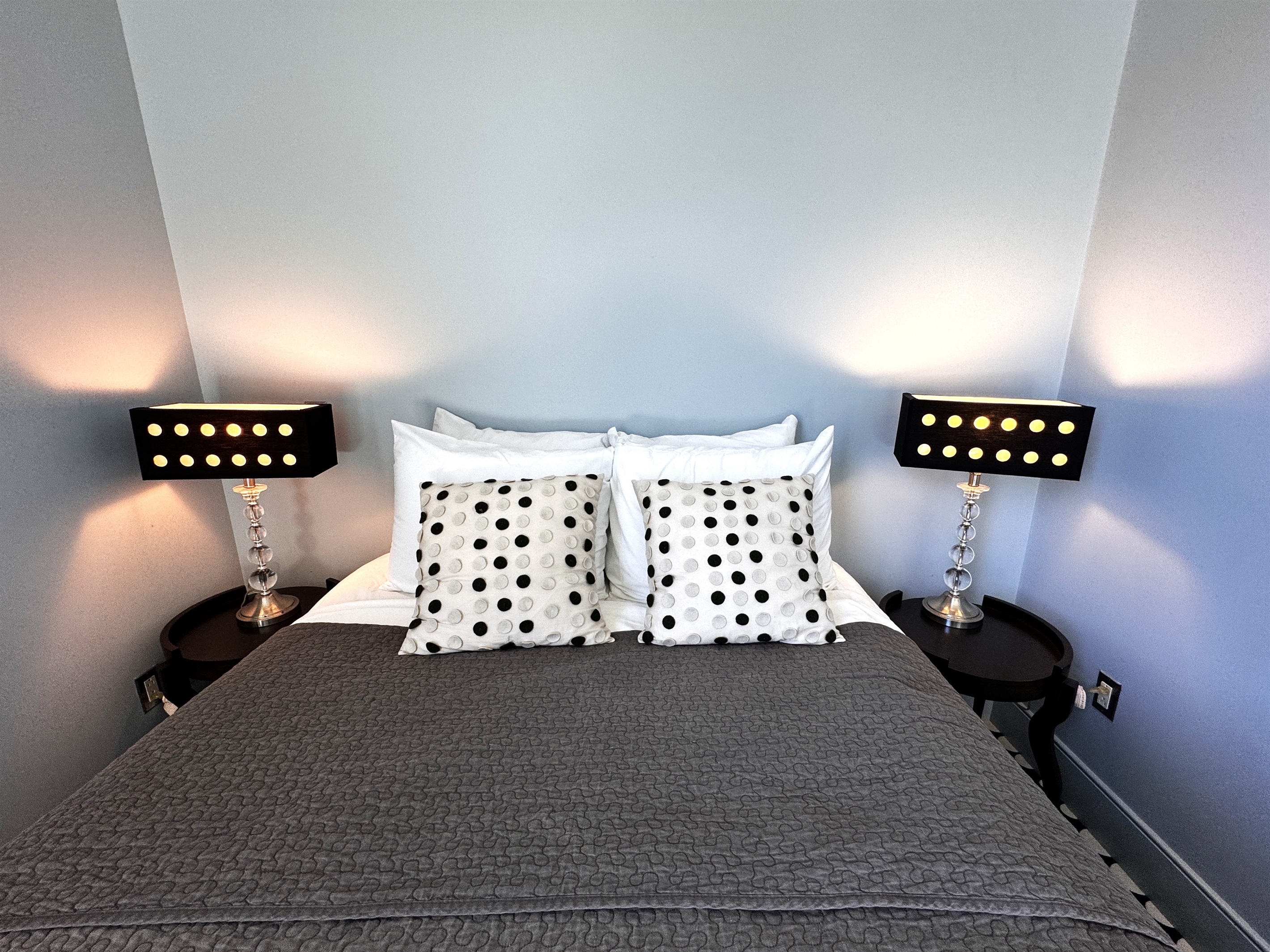 Sophisticated symmetry in the "Sky Loft" queen suite. From the designer lamps to the custom textiles, every detail has been chosen to create a modern, boutique-style retreat at the summit of The Crag.