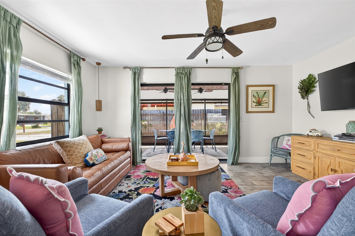 Sliding glass doors in the living room open to an expansive outdoor patio.