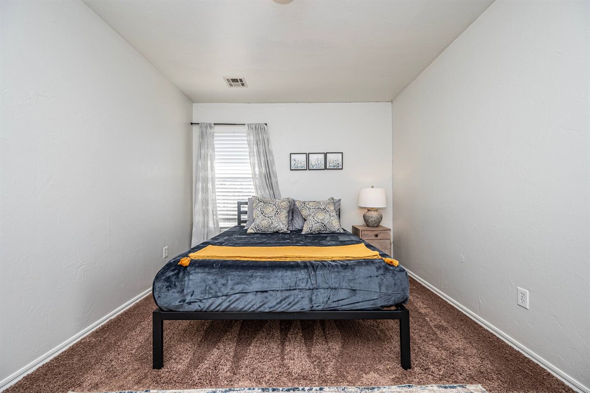 Relax in this stylish secondary bedroom with a comfortable queen bed.