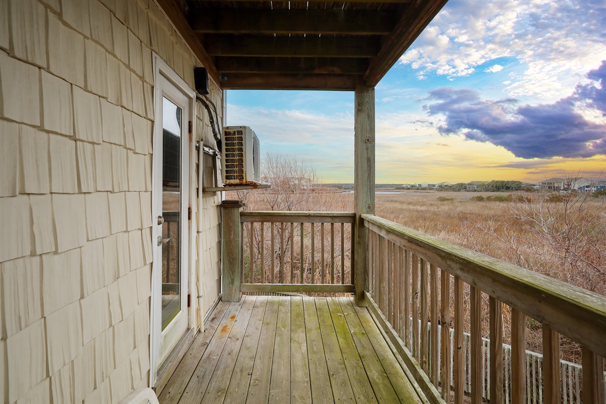 The independent balcony offers wide-open marsh views and colorful coastal skies!