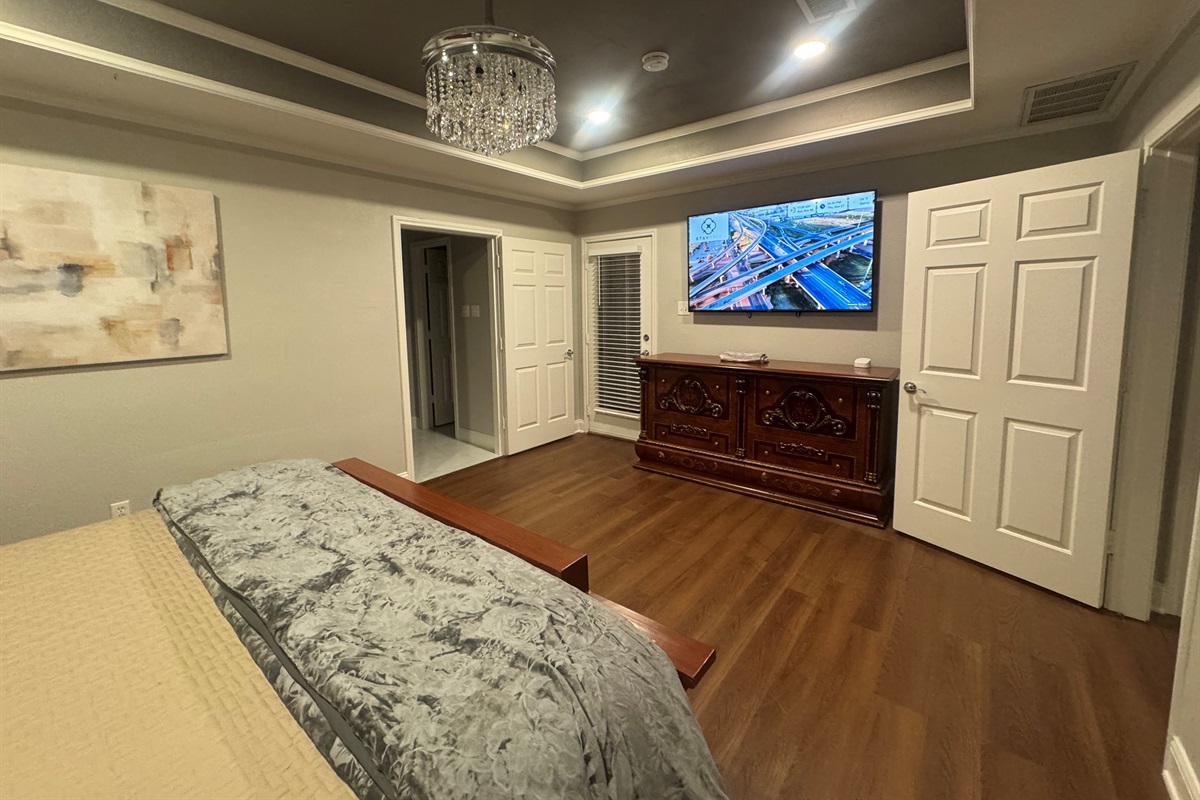 Primary Bedroom w/65 TV and Ensuite Bathroom