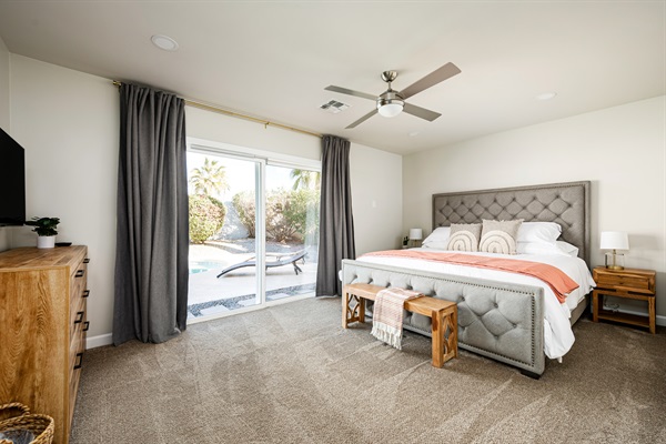 The main bedroom boasts a king sized bed and opens up directly onto the patio and pool area.