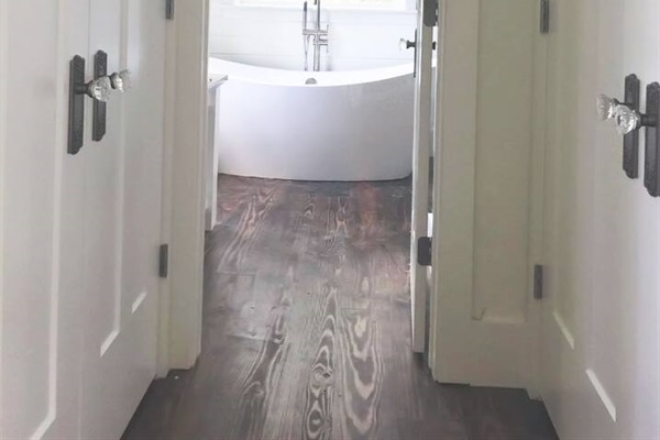 Romantic tub with chandelier in vacation rental