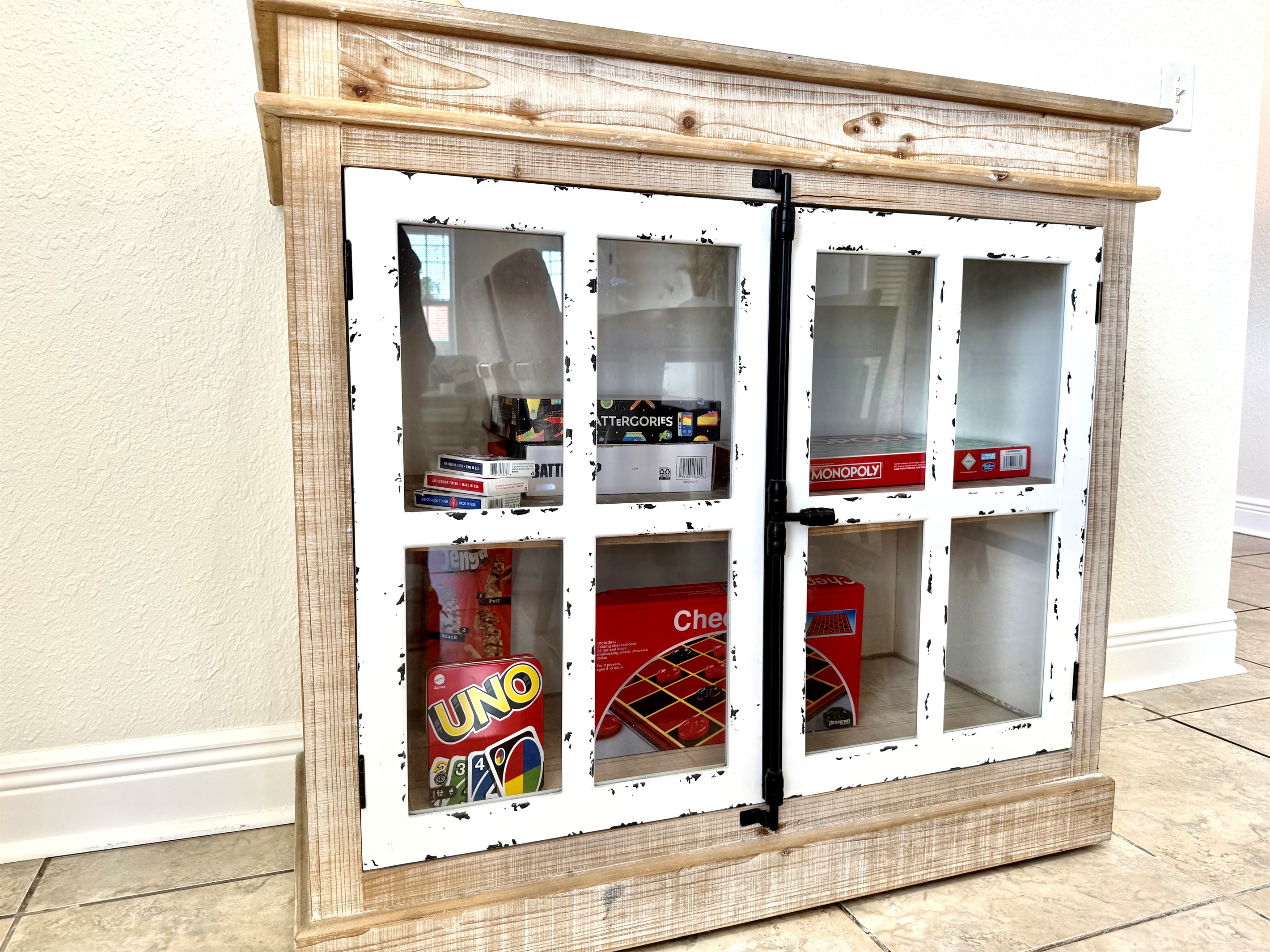 This farmhouse-style cabinet holds a treasure trove of fun! Stocked with board games and card classics, it’s the perfect setup for cozy nights in or rainy day fun for all ages.