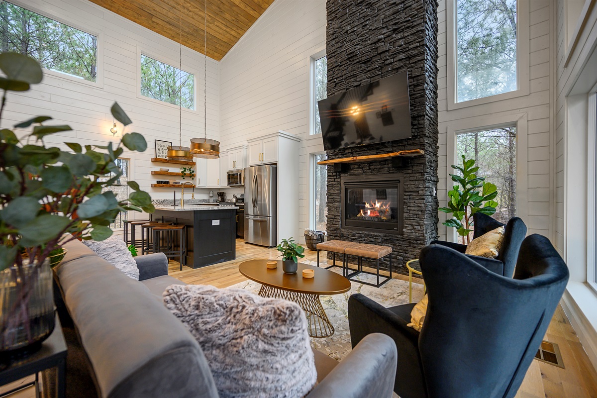 A welcoming main lounge with soft seating, a fireplace, and TV — perfect for relaxing evenings in.