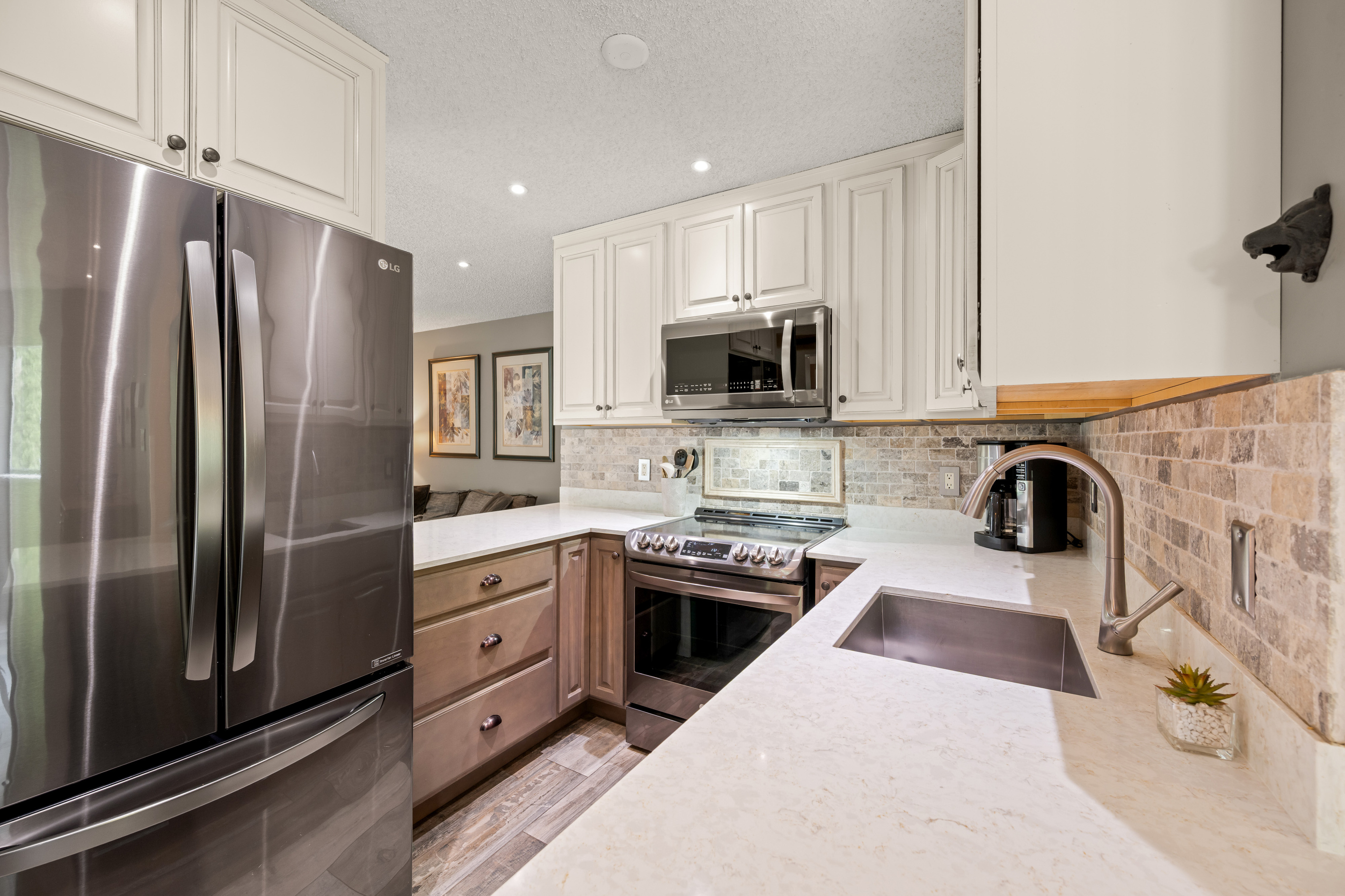 Fully equipped kitchen with a stainless steel fridge and range, dishwasher and microwave, ready for group breakfasts and dinners in.