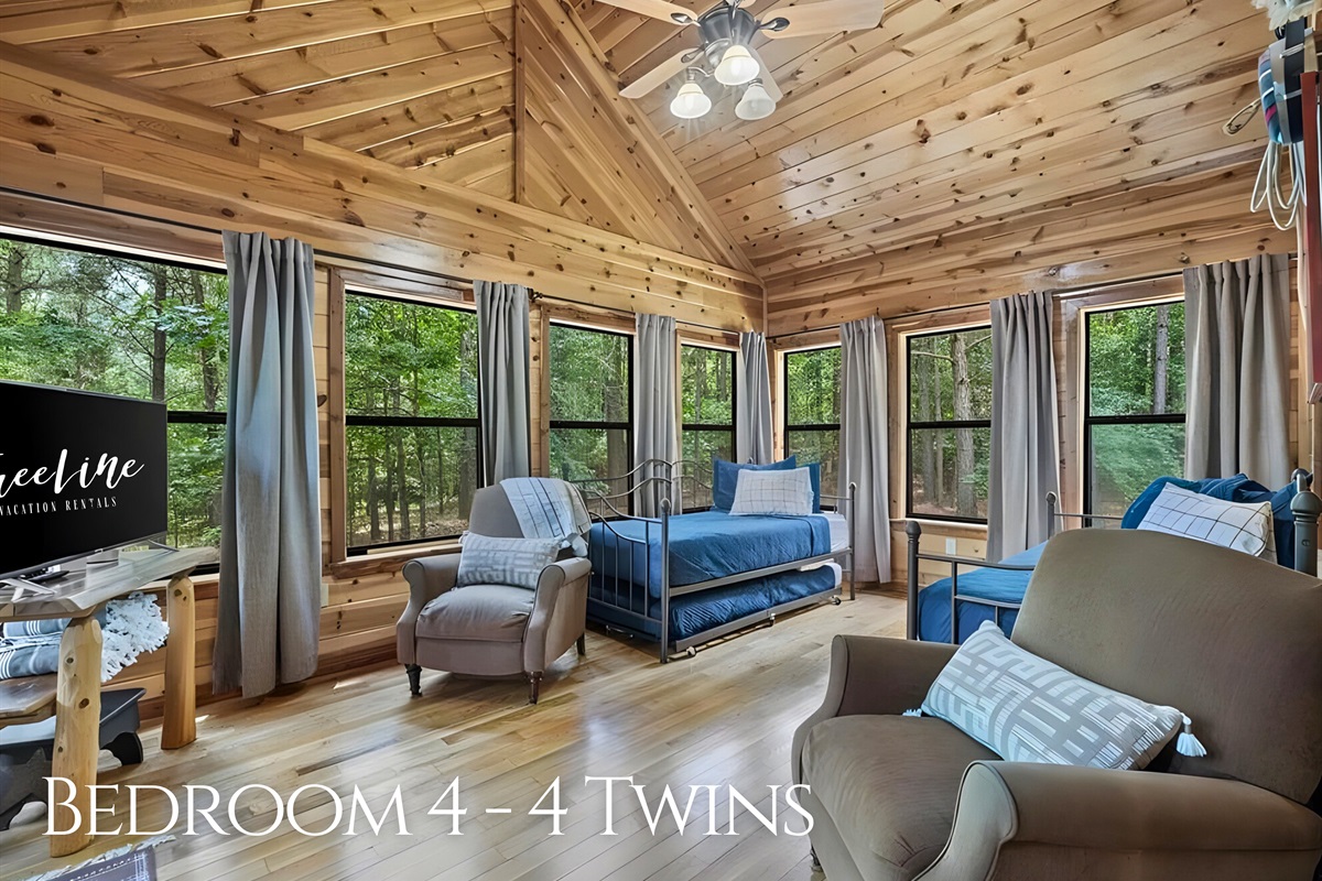 A cheerful, light-filled room with multiple twin beds offers plenty of space for kids or groups to hang out and relax together.