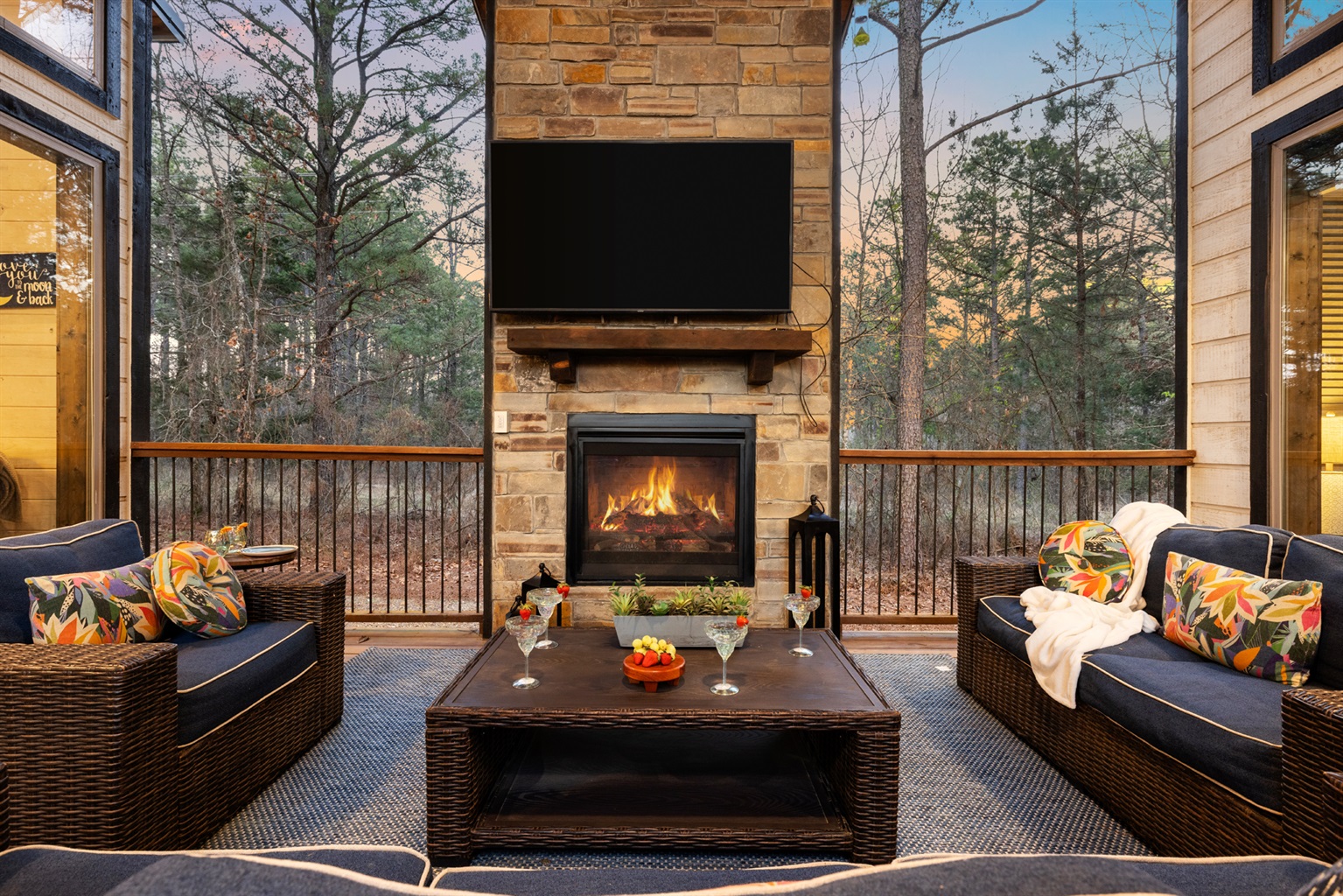 Under the covered breezeway, gather around the outdoor TV and fireplace, grill dinner, share meals, unwind in the hot tub, and cozy up on the conversation set.