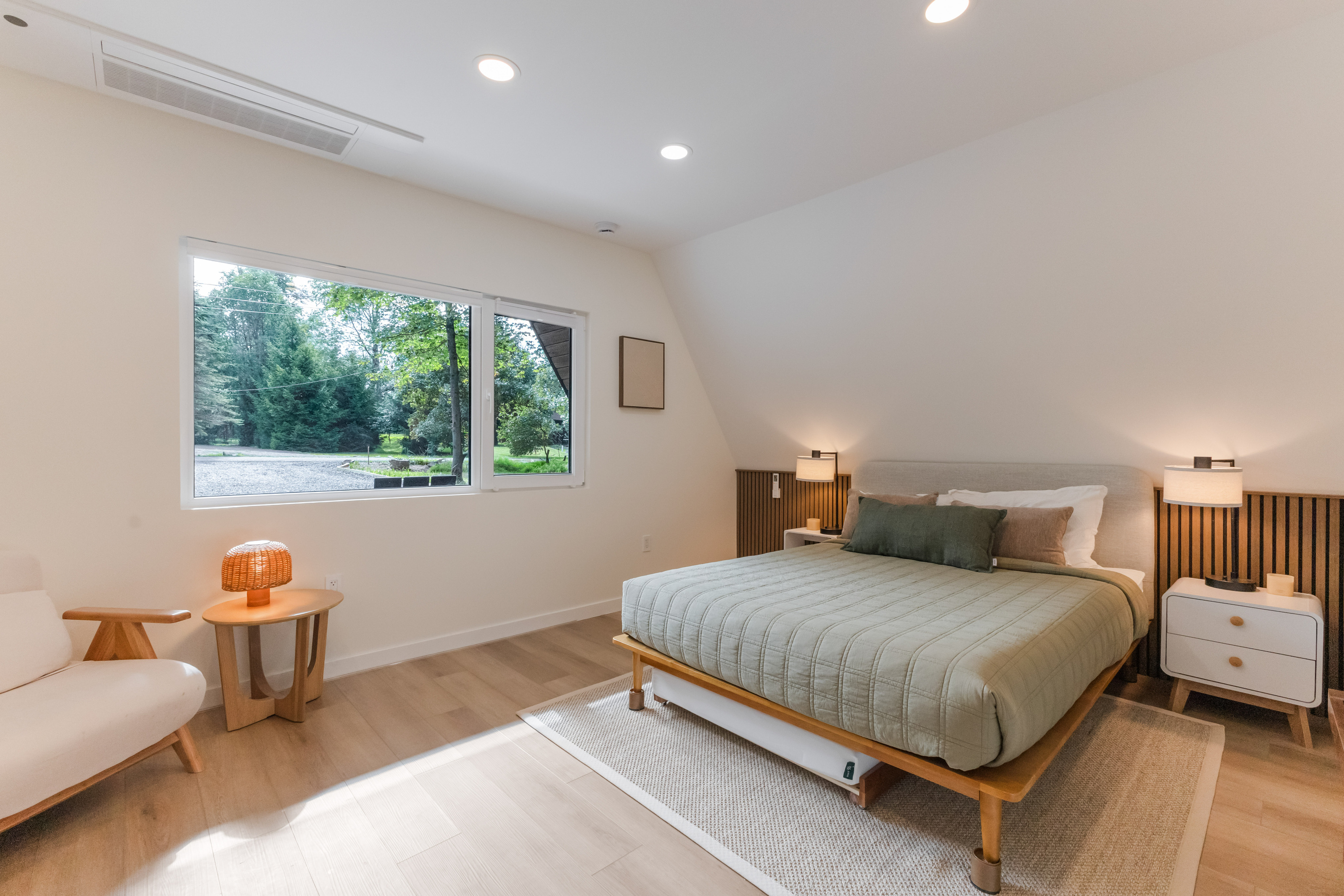 Queen bed, trees out the window