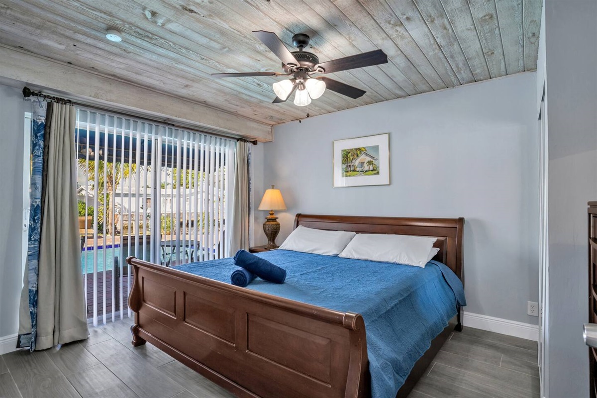 Bedroom 2 Jr Suite with sliding door to the pool, and smart tv.