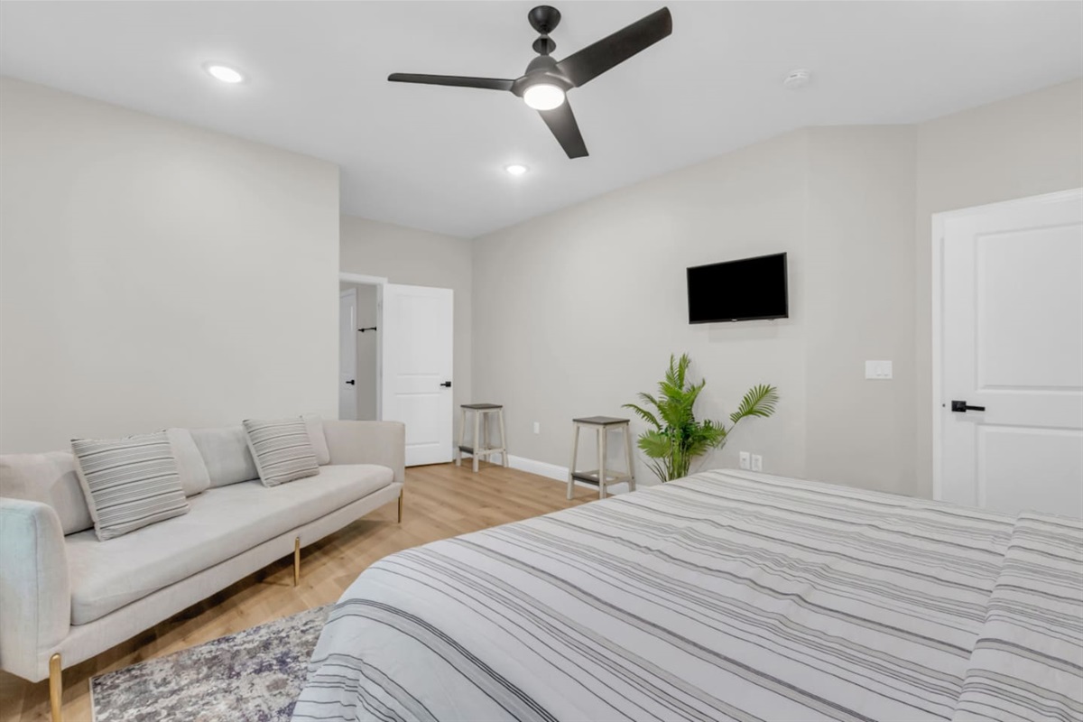 Master suite with king bed and cozy reading nook.