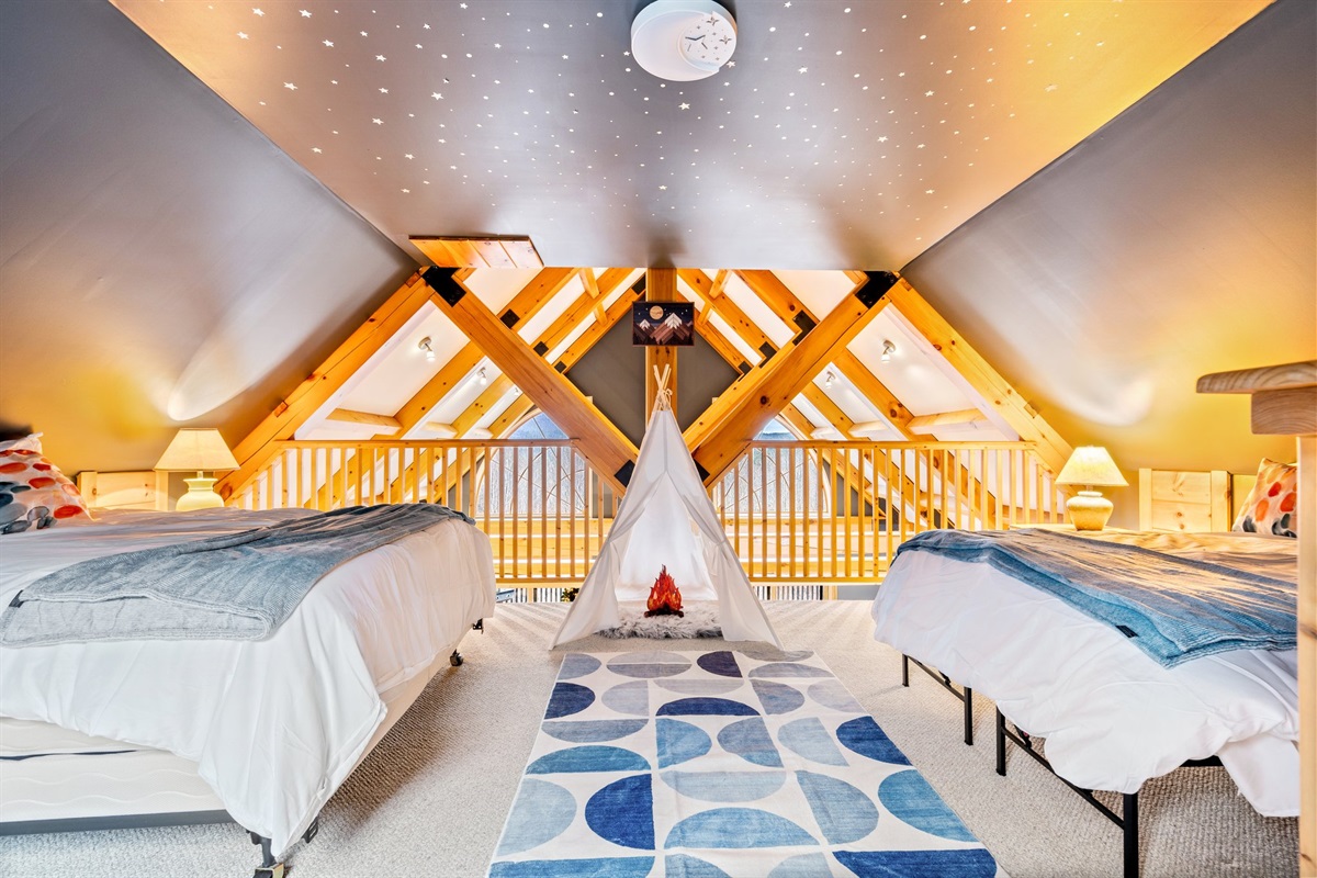 Drift off in the dreamy loft where twin beds, a starry ceiling, and playful touches create a magical retreat.