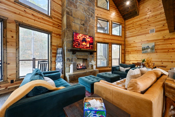 Soaring windows frame the pond outside while warm wood and stone invite you to gather and relax.